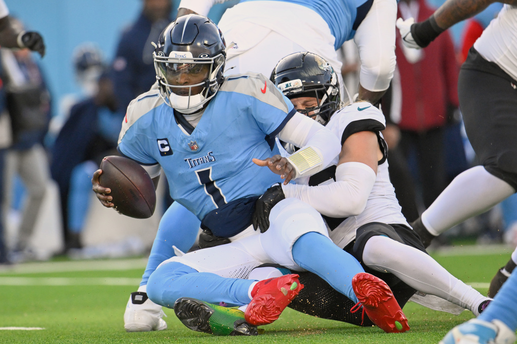 Tennessee Titans quarterback Cam Ward (1) is sacked by Jacksonville Jaguars safety Andrew Wingard during the second half of an NFL football game Sunday, Nov. 30, 2025, in Nashville, Tenn. (AP Photo/John Amis)