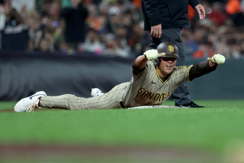 San Diego Padres' Dustin Harris gestures to teammates after hitting an RBI triple during the third inning of a baseball game against the San Francisco Giants in San Francisco, Friday, Sept. 11, 2026. (AP Photo/Jed Jacobsohn)