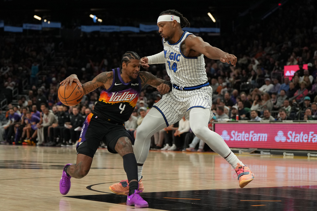 Phoenix Suns guard Jalen Green (4) shields Orlando Magic center Wendell Carter Jr. from the ball during the second half of an NBA basketball game, Saturday, Feb. 21, 2026, in Phoenix. (AP Photo/Rick Scuteri)