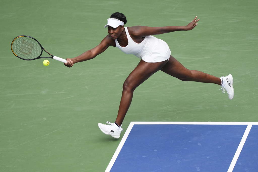 Venus Williams, of the United States, returns a shot to Lyudmyla Kichenok, of the Czech Republic, and Ellen Perez, of Australia, during a first round women's double match of the U.S. Open tennis championships, Thursday, Aug. 28, 2025, in New York. (AP Photo/Yuki Iwamura)