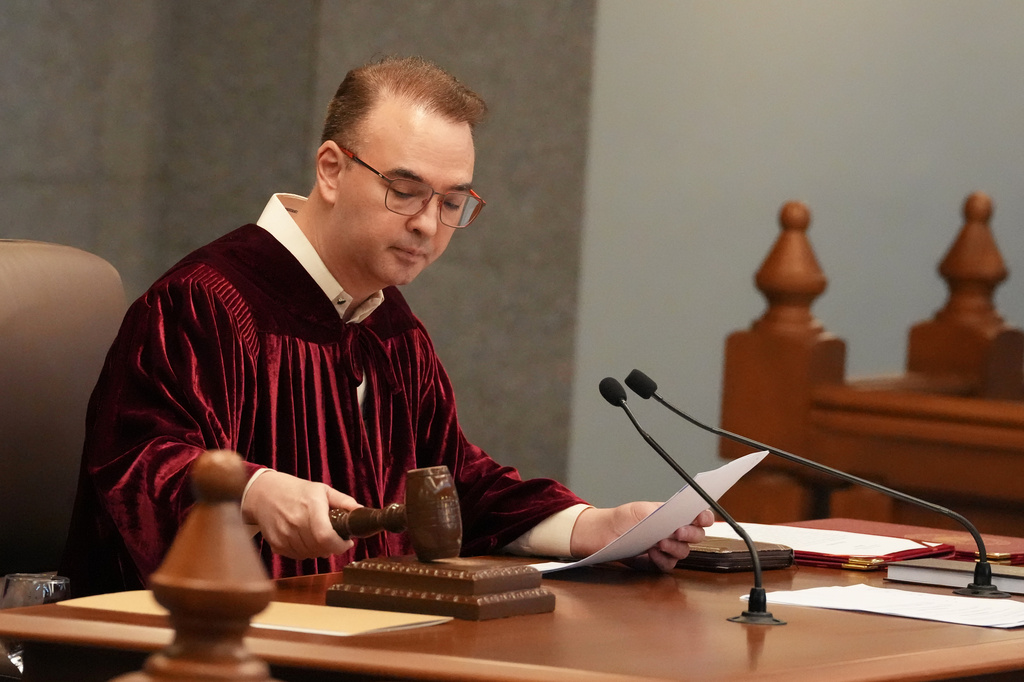 Philippine Senate President Alan Peter Cayetano bangs the gavel as they convene as an impeachment court for the trial of Vice President Sara Duterte at the Philippine senate, Monday, May 18, 2026, in Pasay, Philippines. (AP Photo/Aaron Favila)