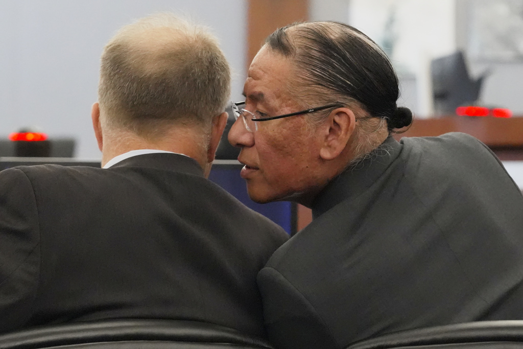 Nathan Chasing Horse, right, talks to his attorney Craig Mueller during his trial on charges of sexually abusing Indigenous women and girls Tuesday, Jan. 13, 2026, in Las Vegas. (AP Photo/Ty ONeil)