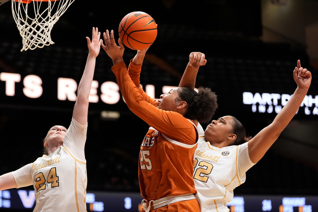 Texas forward Breya Cunningham (25) shoots the ball past Vanderbilt guard Aga Makurat (24) and center Aalyah del Rosario, right, during the first half of an NCAA college basketball game Thursday, Feb. 12, 2026, in Nashville, Tenn. (AP Photo/George Walker IV)