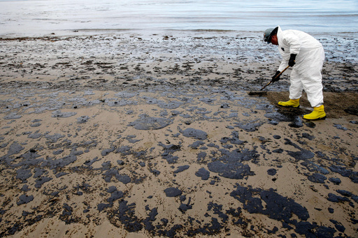 FILE - A worker removes oil from the sand at Refugio State Beach, north of Goleta, Calif., May 21, 2015. (AP Photo/Jae C. Hong, File) FILE - A worker removes oil from the sand at Refugio State Beach, north of Goleta, Calif., May 21, 2015. (AP Photo/Jae C. Hong, File)