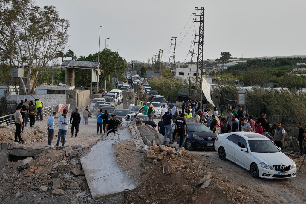 Displaced people returning to their villages following a ceasefire between Hezbollah and Israel, cross the destroyed Qasmiyeh bridge near Tyre city, south Lebanon, Friday, April 17, 2026. (AP Photo/Mohammed Zaatari)