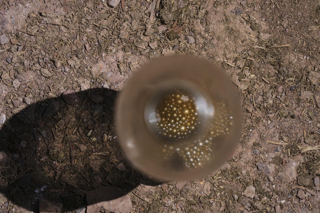A sample of mercury is displayed in a Coca-Cola bottle in San Joaquin, Mexico, Tuesday, Aug. 19, 2025. (AP Photo/Fernando Llano)