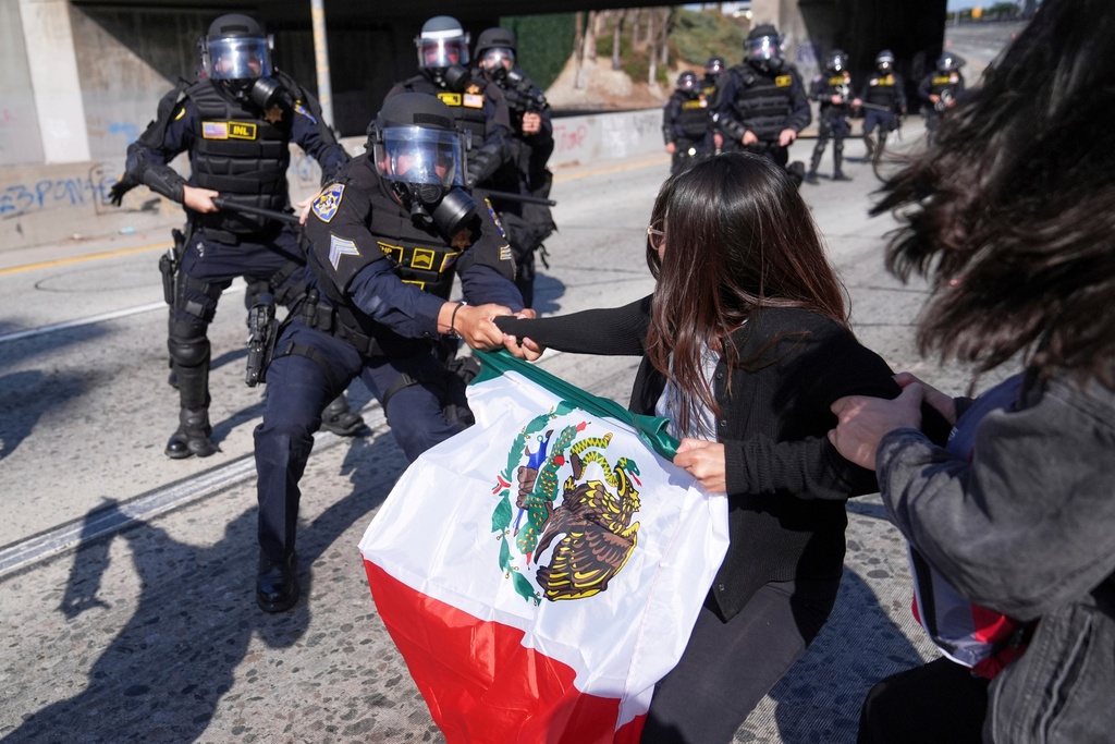 Protesters confront police on the 101 Freeway near the Metropolitan Detention Center in downtown Los Angeles, June 8, 2025, following an immigration raid protest the night before. (AP Photo/Jae C. Hong, File)