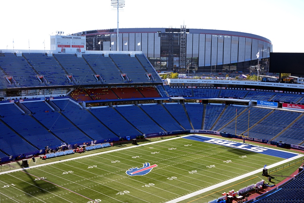 FILE - The Highmark Stadium, foreground, frames the construction on the new Highmark Stadium, upper right, scheduled to open with the 2026 season, shown before an NFL football game between the Buffalo Bills and the New England Patriots, Oct. 5, 2025, in Orchard Park, N.Y. (AP Photo/Gene J. Puskar, File)