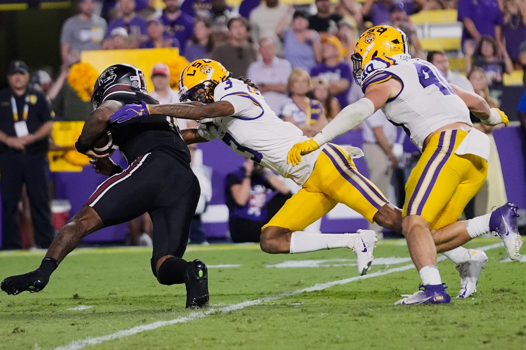 FILE - South Carolina quarterback Lanorris Sellers (16) is sacked by LSU cornerback DJ Pickett (3) and linebacker Whit Weeks (40) in the second half of an NCAA college football game, Oct. 11, 2025 in Baton Rouge, La. (AP Photo/Gerald Herbert, File)