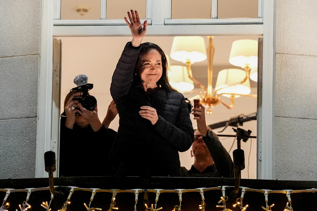 Nobel Peace Prize laureate Maria Corina Machado waves at the Grand Hotel in Oslo, Norway, early Thursday, Dec. 11, 2025. (Lise Åserud/NTB Scanpix via AP)