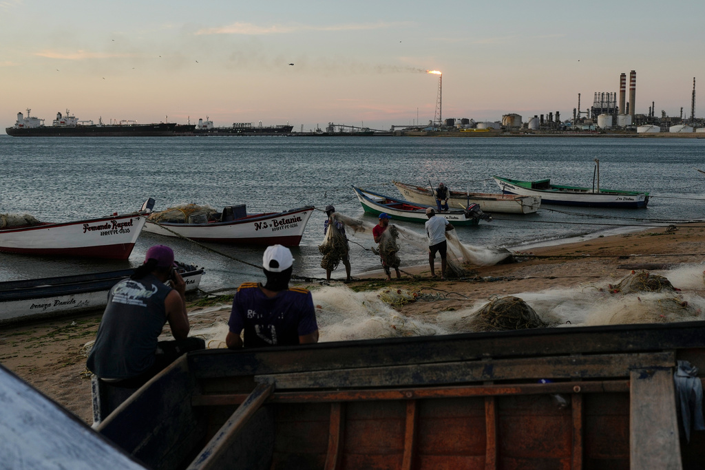 Fishermen ready the nets as oil tankers are docked at the Cardon refinery in Punta Cardon, Venezuela, Wednesday, Jan. 14, 2026. (AP Photo/Matias Delacroix)