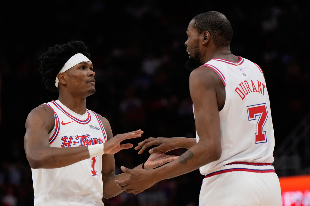 Houston Rockets guard Amen Thompson (1) celebrates with forward Kevin Durant (7) during the first half of an NBA basketball game against the New York Knicks in Houston, Tuesday, March 31, 2026. (AP Photo/Ashley Landis)