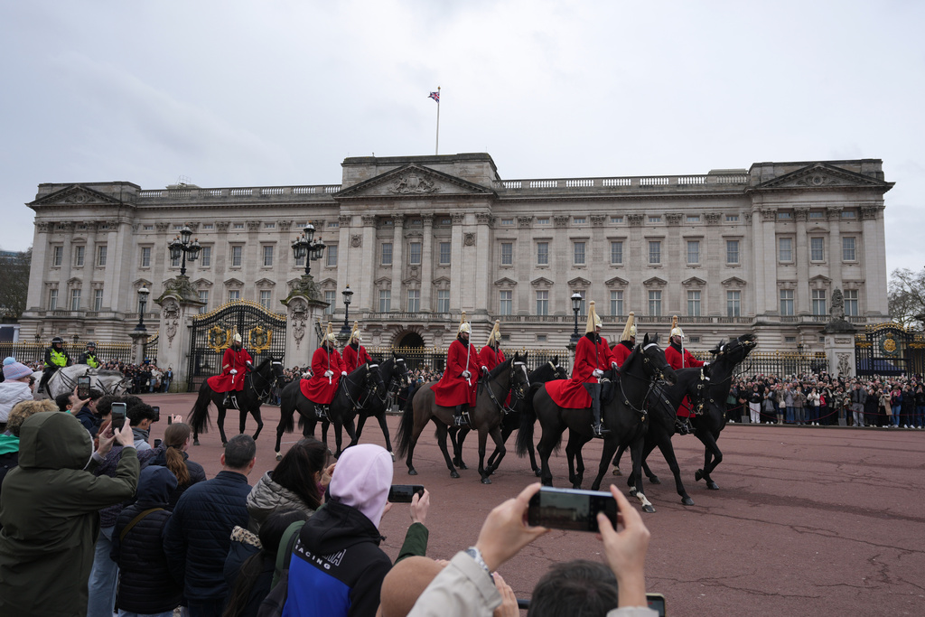 Soldiers parade during Guard's Change at Buckingham Palace in London, Friday, Feb. 20, 2026 after Andrew Mountbatten-Windsor was arrested and held for hours by British police on suspicion of misconduct in public office related to his links to Jeffrey Epstein.(AP Photo/Kin Cheung)