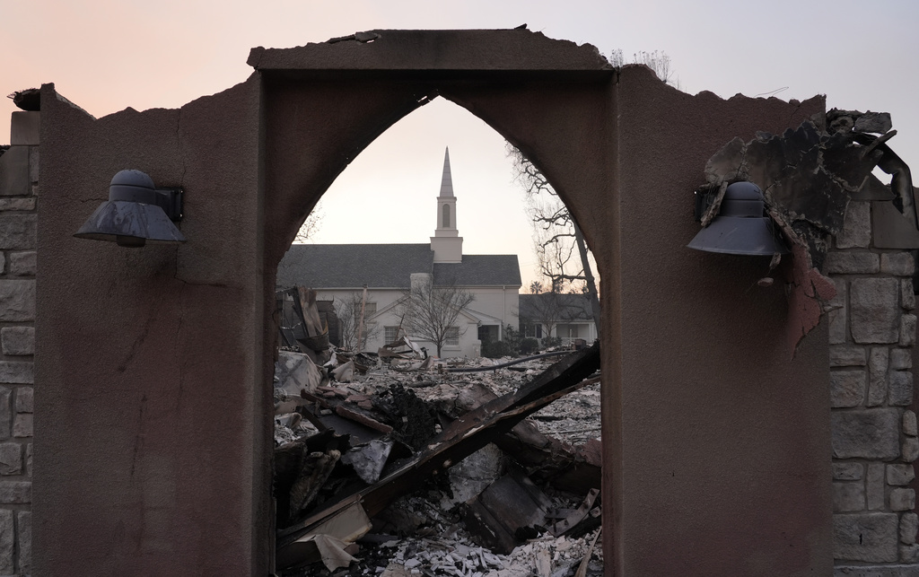 The intact First Church of Christ, Scientist is framed through the ruins of St. Mark's Episcopal Church next door, Thursday, Jan. 9, 2025, in Altadena, Calif. (AP Photo/Chris Pizzello)