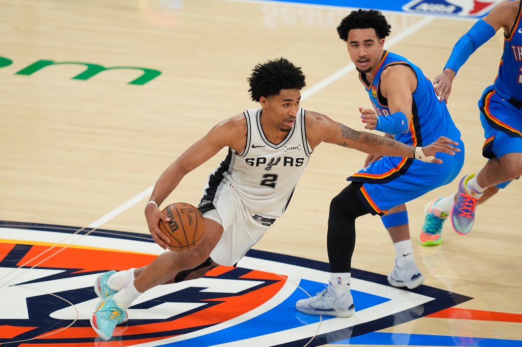 San Antonio Spurs guard Dylan Harper (2) controls the ball during the second half of Game 2 in the Western Conference finals NBA basketball playoffs series against the Oklahoma City Thunder Wednesday, May 20, 2026, in Oklahoma City. (AP Photo/Tony Gutierrez)