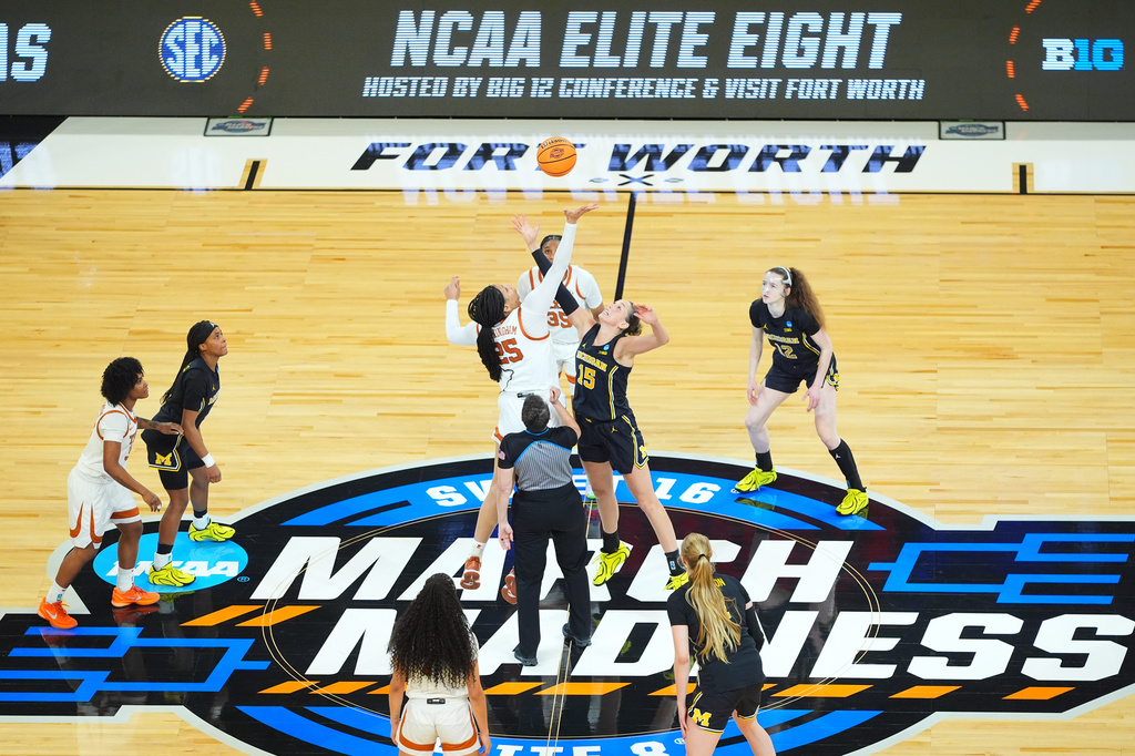 Michigan and Texas tip off during the first half in the Elite Eight of the NCAA college basketball tournament, Monday, March 30, 2026, in Fort Worth, Texas. (AP Photo/LM Otero)