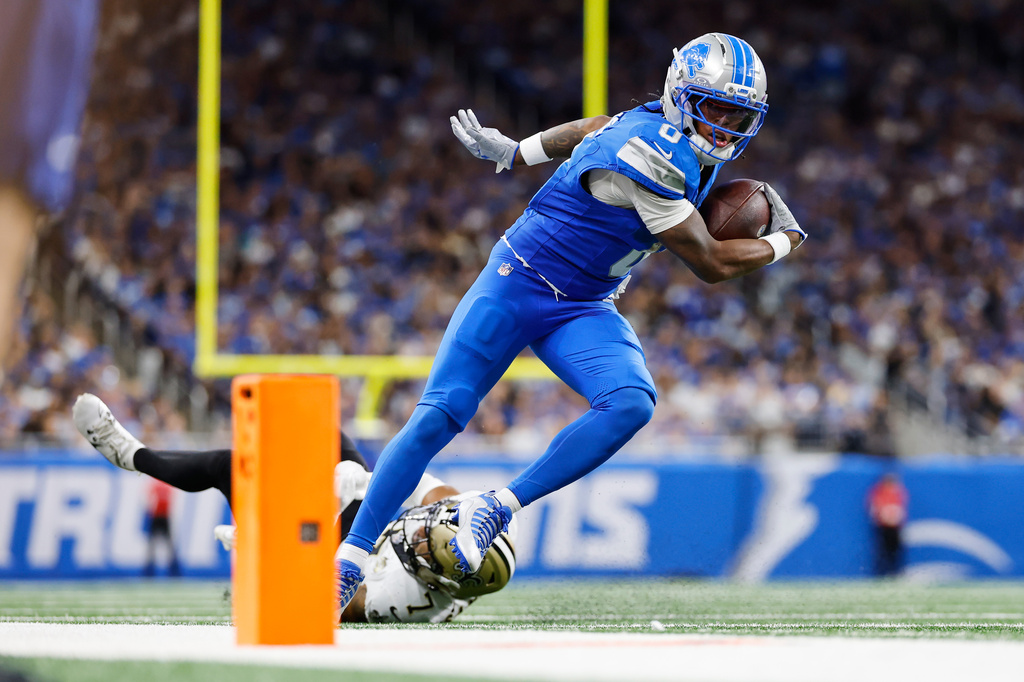 Detroit Lions running back Jahmyr Gibbs (0) caries against New Orleans Saints safety Jonas Sanker (7) in the second half of an NFL football game, Sunday, Sept. 13, 2026, in Detroit. (AP Photo/Rey Del Rio)