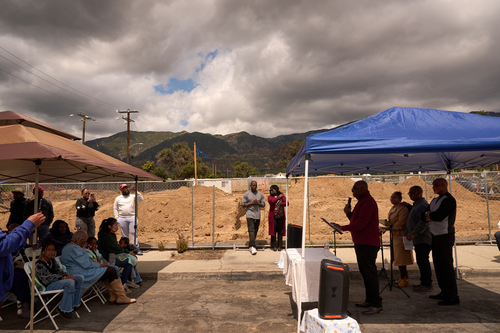 Pastor Jonathan Lewis, fourth from right, holds a groundbreaking service at the site of the burned Fountain of Life Nazarene Church to mark the beginning of its rebuilding in Altadena, Calif., April 26, 2026. (AP Photo/Damian Dovarganes)