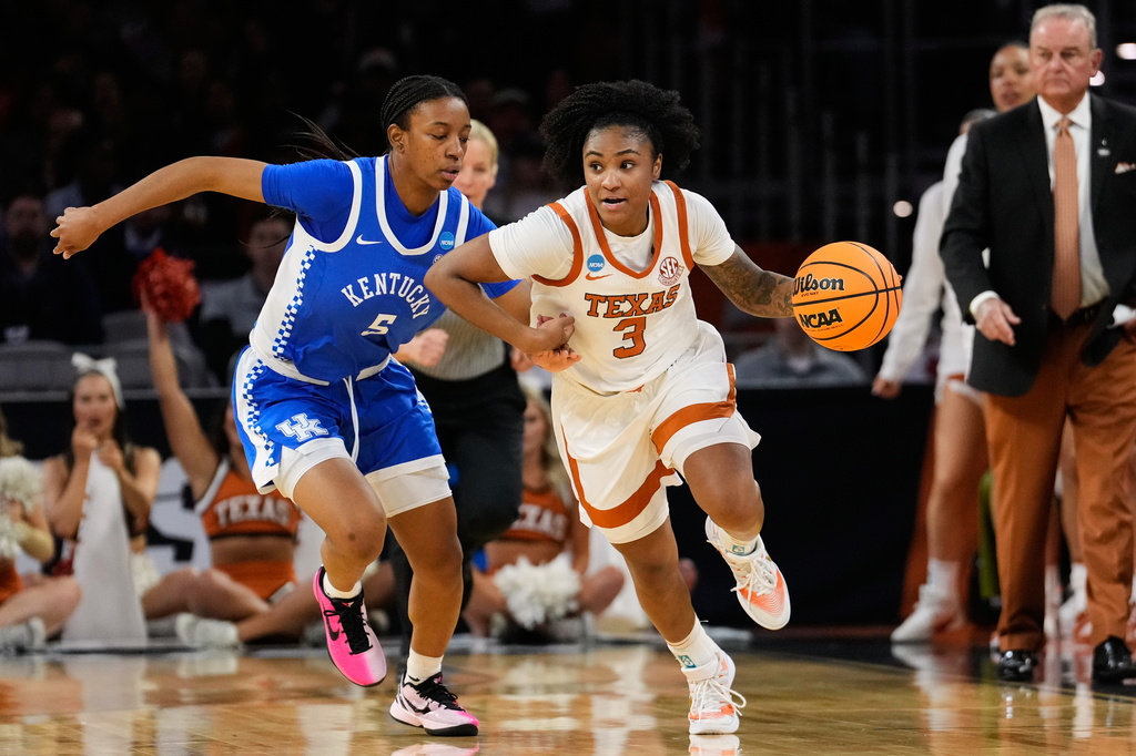 Texas guard Rori Harmon (3) drives the ball upcourt as Kentucky's Tonie Morgan (5) defends in the first half in the Sweet 16 of the NCAA college basketball tournament, Saturday, March 28, 2026, in Fort Worth, Texas. (AP Photo/Tony Gutierrez)