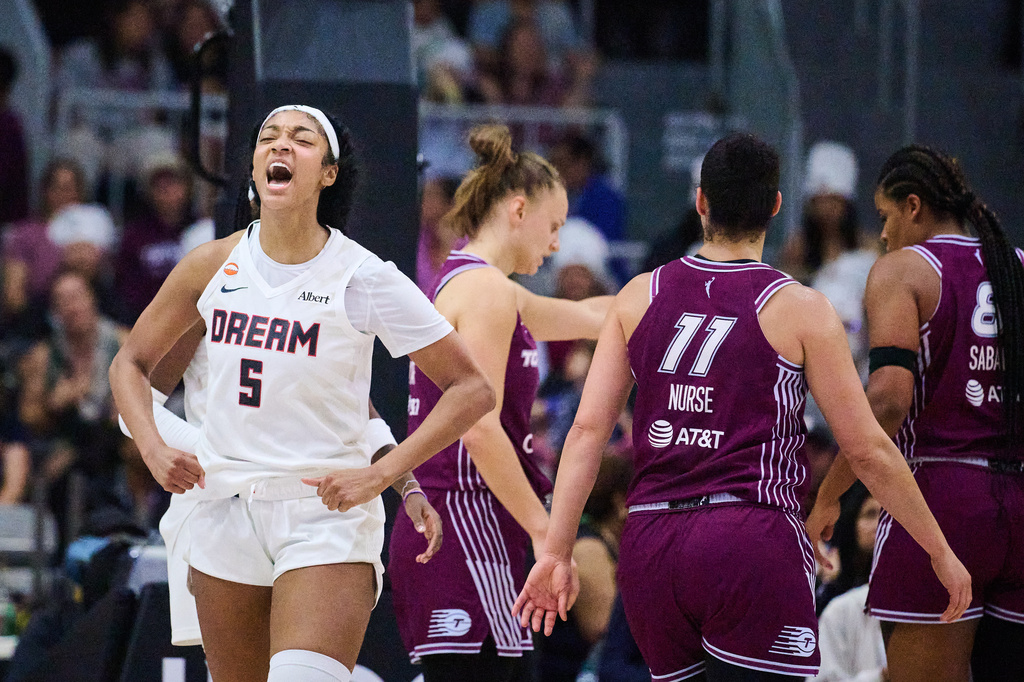 Atlanta Dream's Angel Reese (5) celebrates after scoring against the Toronto Tempo during the first half of a WNBA basketball game in Toronto, Friday, July 17, 2026. (Sammy Kogan/The Canadian Press via AP)