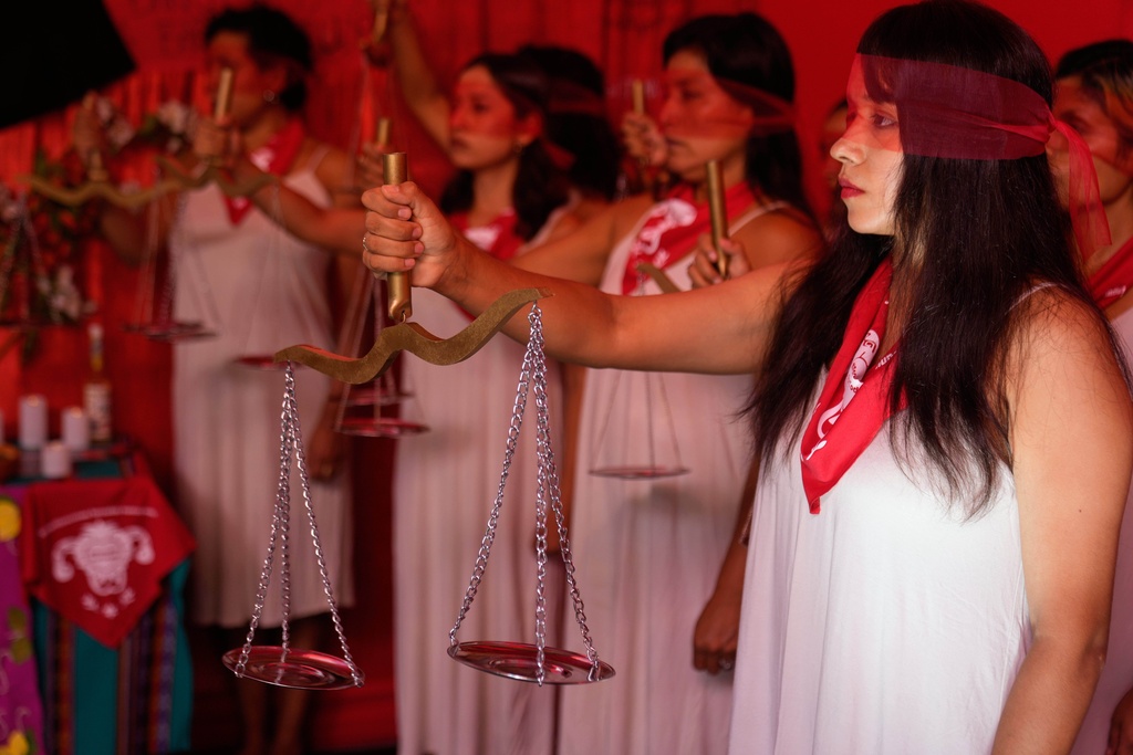 Demonstrators perform representing the female victims of a forced sterilization program under the administration of late Peruvian President Alberto Fujimori in Lima, Peru, Friday, March 6, 2026. (AP Photo/Martin Mejia)