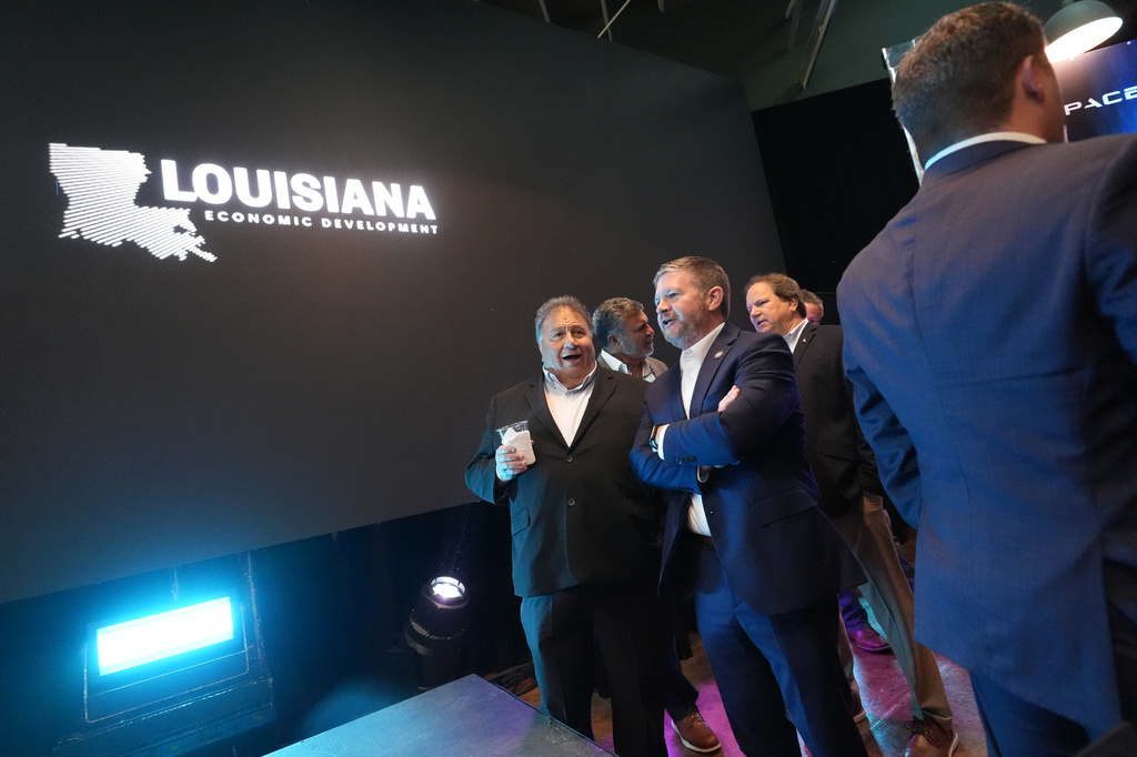 Guests gather before the start of an event with Louisiana Gov. Jeff Landry and SpaceX announcing a deal to build a new spaceport in Louisiana, Tuesday, Aug. 25, 2026, in Abbeville, La. (AP Photo/Gerald Herbert)