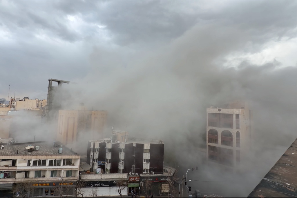 Smoke engulfs a street after a strike in Tehran, Iran, Monday, March 2, 2026. (AP Photo/Mohsen Ganji)