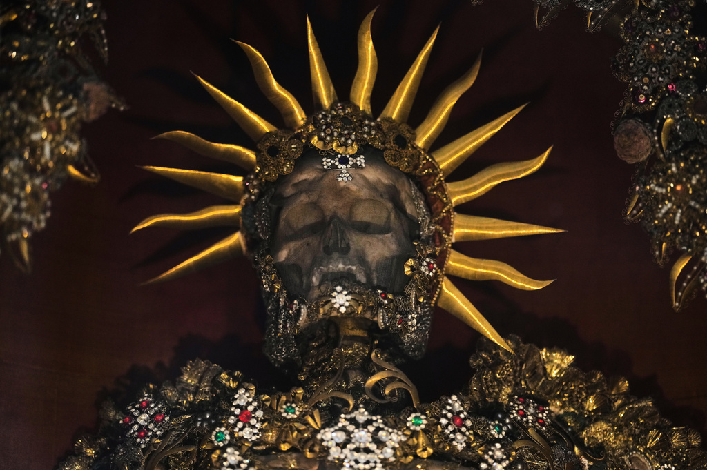 An elaborately decorated skeleton lies in the catholic monastery church of Banz in Bad Staffelstein, Germany, Saturday, May 2, 2026. (AP Photo/Matthias Schrader)