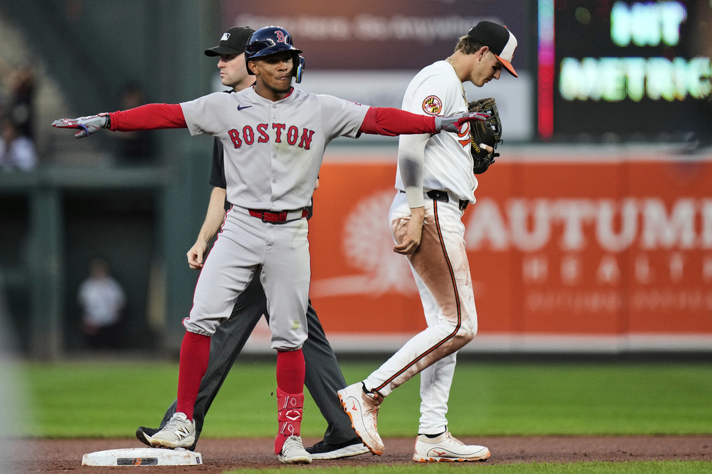 Boston Red Sox's Ceddanne Rafaela, left, celebrates after hitting a double during the fourth inning of a baseball game against the Baltimore Orioles, Wednesday, Aug. 27, 2025, in Baltimore. (AP Photo/Stephanie Scarbrough)