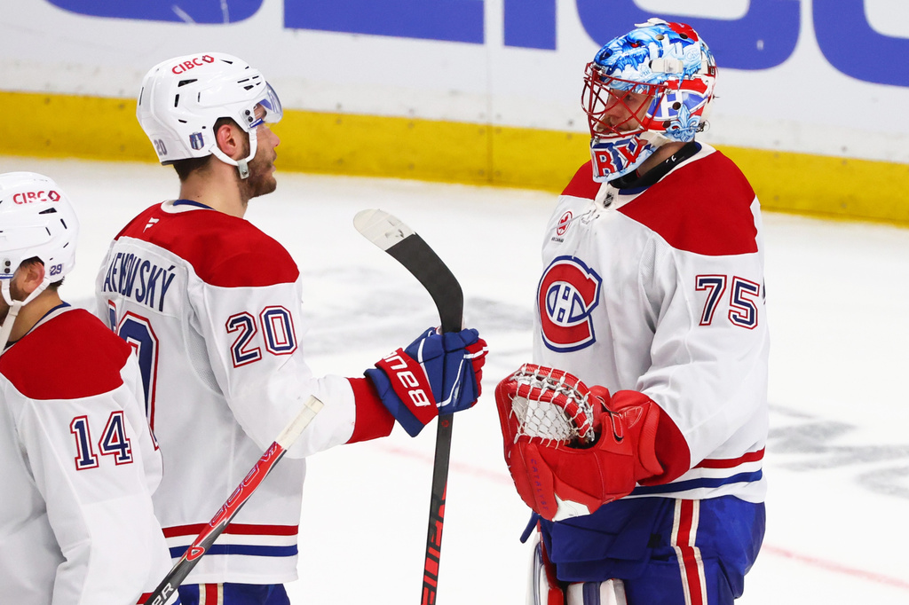 Montreal Canadiens goaltender Jakub Dobes (75) and left wing Juraj Slafkovský (20) celebrate victory following the third period in Game 5 of a second-round NHL hockey Stanley Cup playoff series against the Buffalo Sabres, Thursday, May 14, 2026, in Buffalo, N.Y. (AP Photo/Jeffrey T. Barnes)