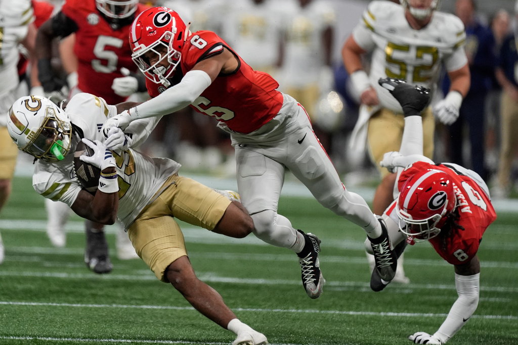 Georgia Tech wide receiver Jordan Allen (85) dives against Georgia defensive back Daylen Everette (6) during the first half of an NCAA college football game, Friday, Nov. 28, 2025, in Atlanta. (AP Photo/Mike Stewart)