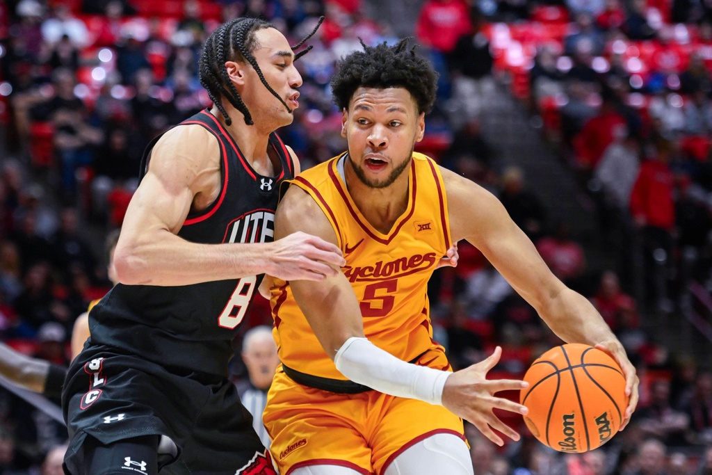Iowa State forward Joshua Jefferson (5) dribbles into Utah forward Keanu Dawes (8) during the second half of an NCAA college basketball game, Tuesday, Feb. 24, 2026, in Salt Lake City. (AP Photo/Alex Goodlett)