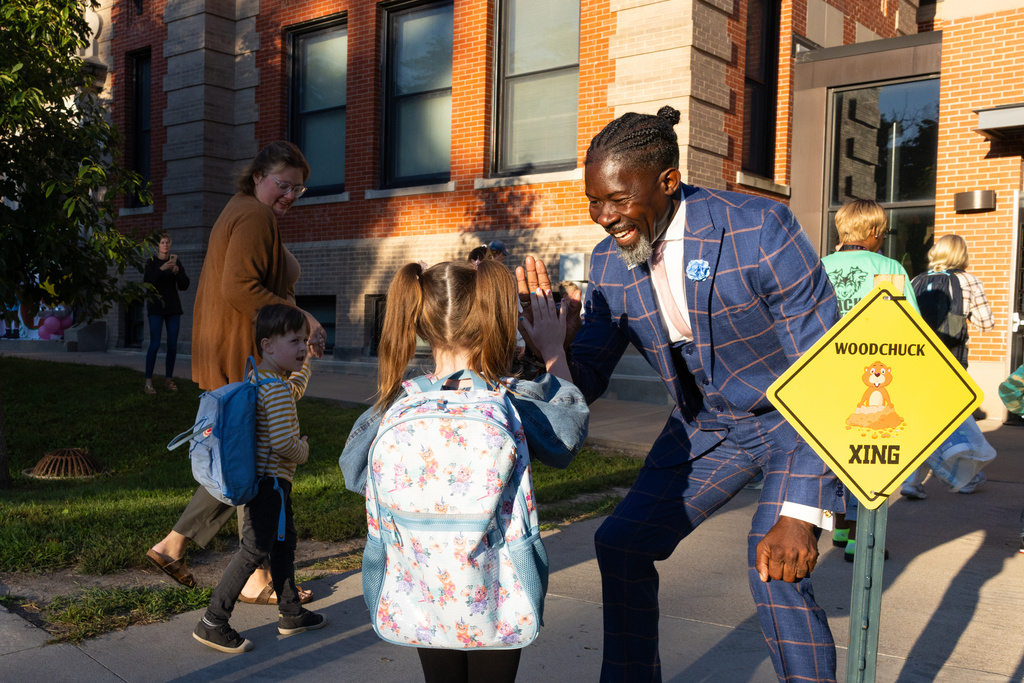 Ian Roberts, superintendent of Des Moines Public Schools, greets students at Greenwood Elementary School in Des Moines, Aug. 25, 2025. (Jon Lemons/Des Moines Public Schools via AP)