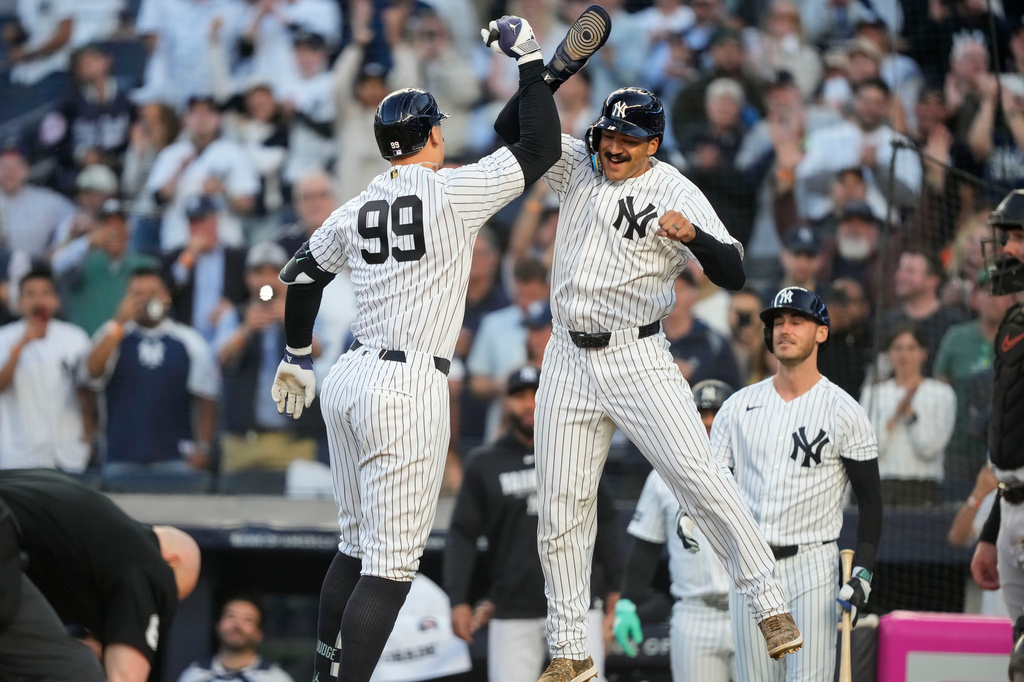 New York Yankees' Aaron Judge (99) celebrates with New York Yankees' Trent Grisham, center right, after hitting a two-run home run during the first inning of a baseball game against Baltimore Orioles, Monday, May 4, 2026, in New York. (AP Photo/Yuki Iwamura)