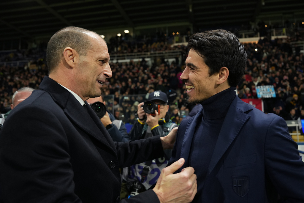 AC Milan's head coach Massimiliano Allegri, left, and Parma's head coach Carlos Cuesta greet each other prior to the Serie A soccer match between Parma and Milan in Parma, Italy, Sunday, Nov. 8, 2025. (Massimo Paolone/LaPresse via AP)