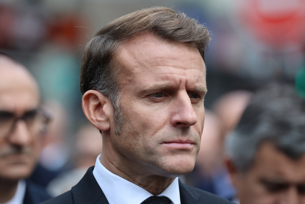 French President Emmanuel Macron pays his respects to victims near Le Bonne Biere cafe, Thursday Nov. 13, 2025 in Paris during ceremonies marking the 10th anniversary of terrorist attacks that killed 132 people and injured hundreds. (Ludovic Marin, Pool photo via AP)