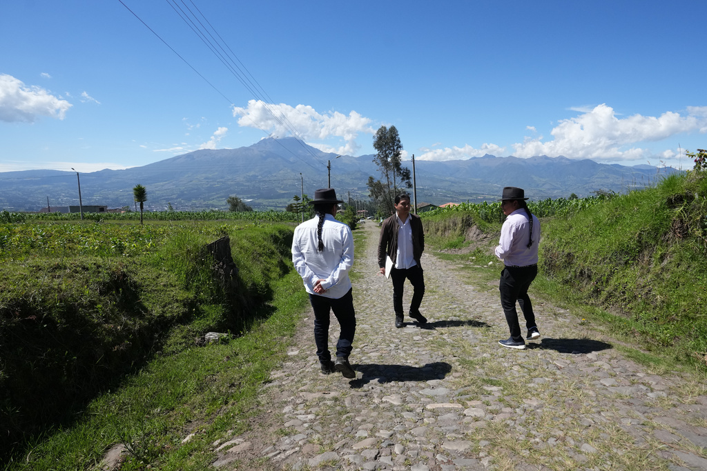From left, Malkik Anrango, Yarik Sisa and Tupac Amaru walk among landscape they aim to capture in "Aya Somos," the first Quichua animated short, blending Otavalo culture with Japanese-style anime, in Hatun Rumi, Ecuador, Wednesday, Dec. 3, 2025. (AP Photo/Dolores Ochoa)