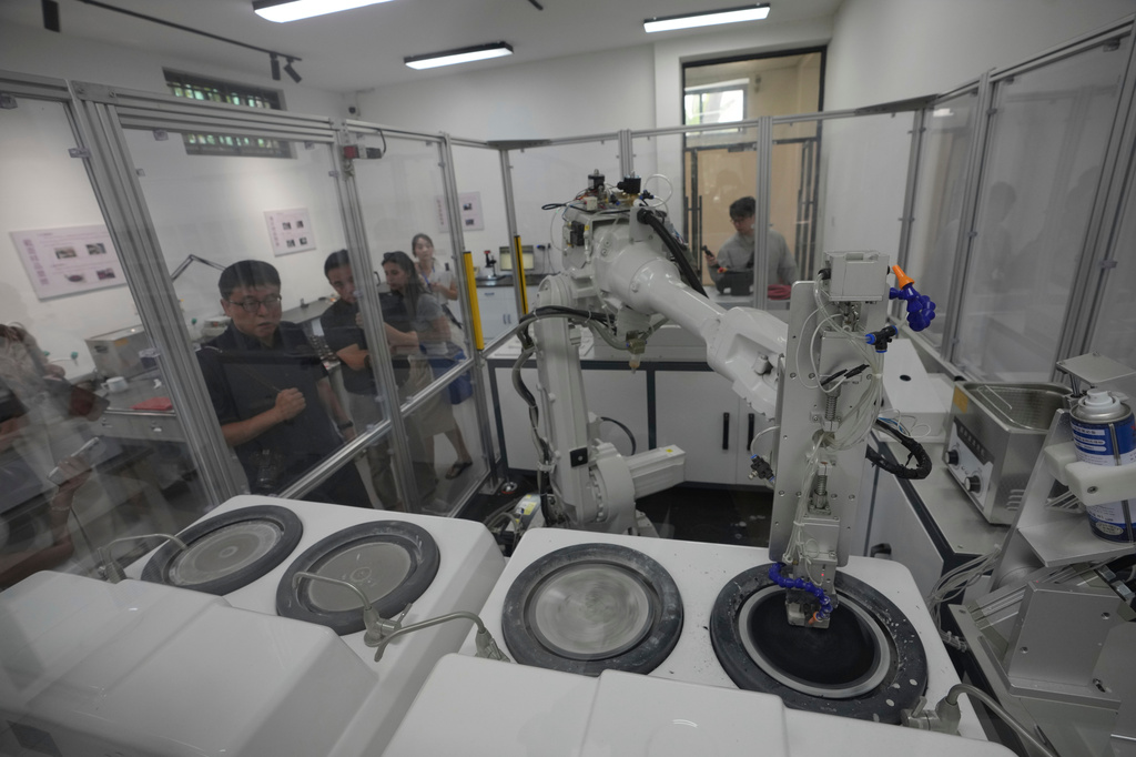 A robot with artificial intelligence helps to match and reconstruct ancient porcelain fragments at the Jingdezhen Imperial Kiln Institute which specializes in the research and restoration of ceramics excavated from the city's historic imperial kiln sites in Jingdezhen, in eastern China's Jiangxi province, Monday, Aug. 31, 2026. (AP Photo/Achmad Ibrahim)