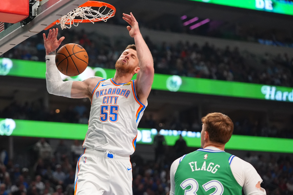 Oklahoma City Thunder center Isaiah Hartenstein (55) scores in front of Dallas Mavericks forward Cooper Flagg during the first half of an NBA basketball game in Dallas, Monday, Oct. 27, 2025. (AP Photo/LM Otero)