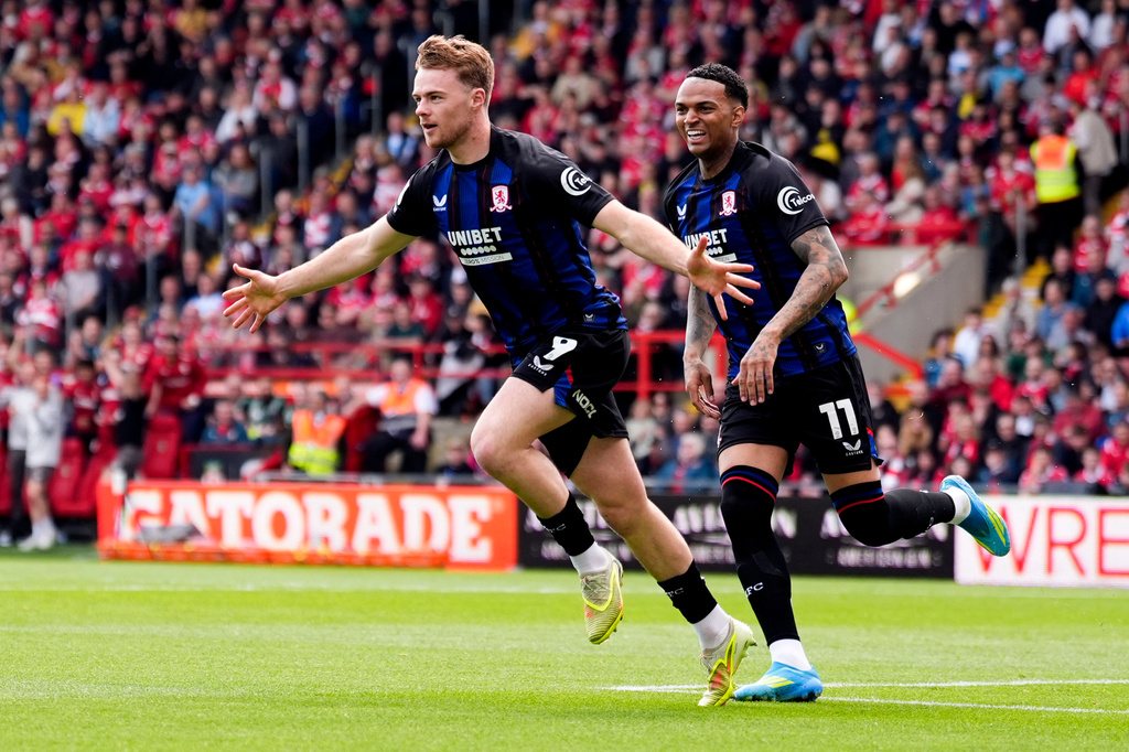 Middlesbrough's Tommy Conway, left, celebrates scoring the opening goal during the EFL Championship soccer match between Wrexham and Middlesbrough, in Wrexham, Wales, Saturday May 2, 2026. (Peter Byrne/PA via AP)