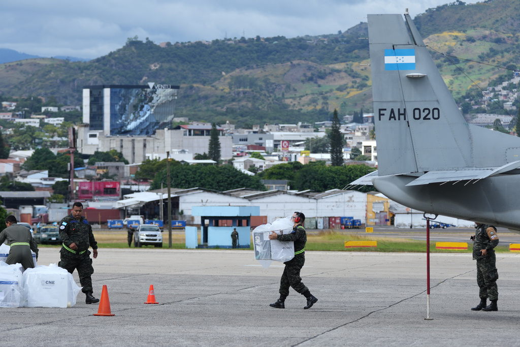 Soldiers unload ballot boxes from rural polling stations, at the airport in Tegucigalpa, Honduras, Monday, Dec. 1, 2025. (AP Photo/Moises Castillo)