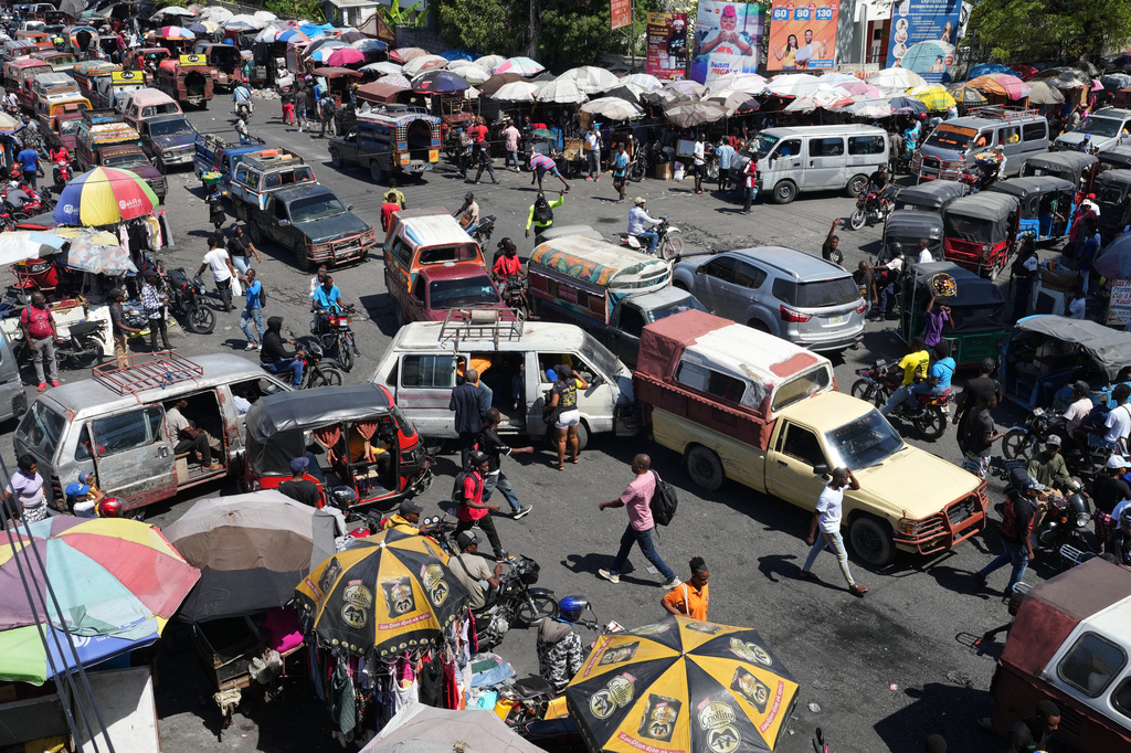 Vehicles crowd an intersection in the Delmas neighborhood of Port-au-Prince, Haiti, Friday, April 10, 2026. (AP Photo/Odelyn Joseph)