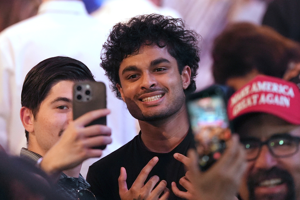 People pose for a photo after President Donald Trump spoke at a Turning Point USA event at Dream City Church, Friday, April 17, 2026, in Phoenix. (AP Photo/Ross D. Franklin)