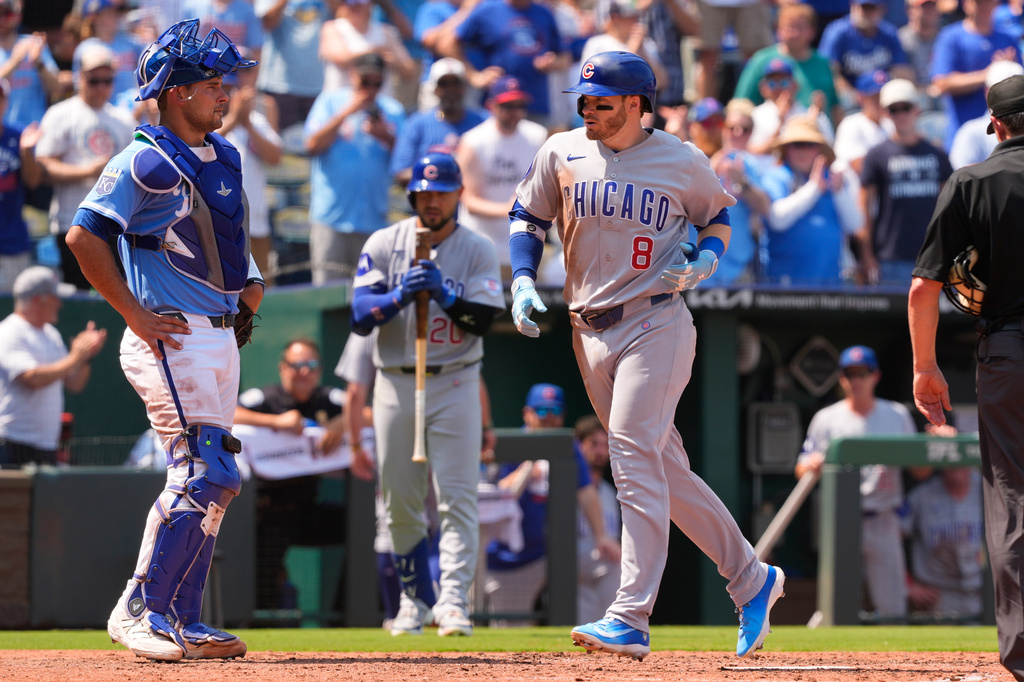Chicago Cubs' Ian Happ crosses the plate after hitting a two-run home run during the sixth inning of a baseball game against the Kansas City Royals, Sunday, Aug. 9, 2026, in Kansas City, Mo. (AP Photo/Charlie Riedel)