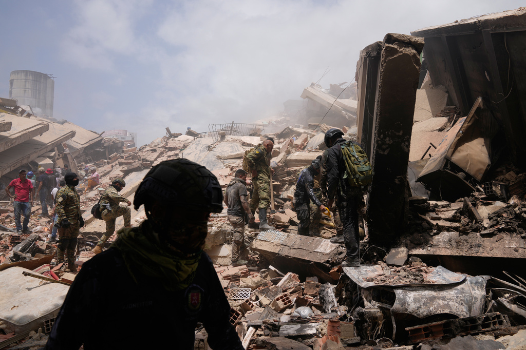 Venezuelan Police searches through the rubble two days after earthquake struck La Guaira, Venezuela, Friday, June 26, 2026. (AP Photo/Ariana Cubillos)