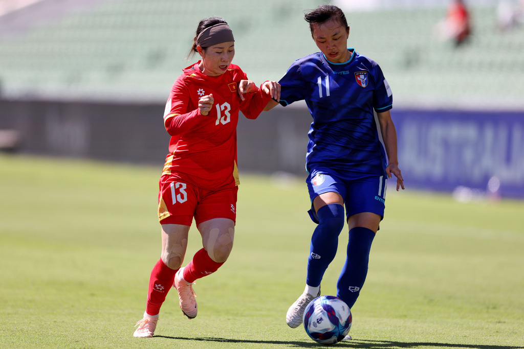 Vietnam's Lê Thị Diễm My, left, and Taiwan's He Jia-Shiuan battle for the ball during the Women's Asian Cup soccer match between Taiwan and Vietnam in Perth, Australia, Saturday, March 7, 2026. (Colin Murty/AAPImage via AP)