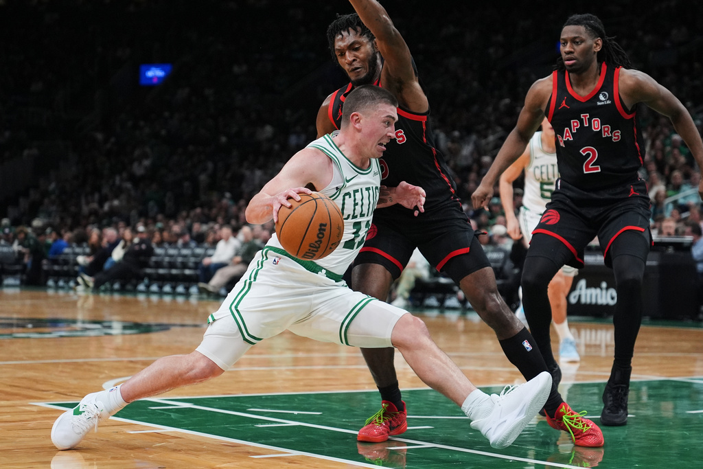 Boston Celtics guard Payton Pritchard (11) drives to the basket against the Toronto Raptors during the second half of an NBA basketball game, Friday, Jan. 9, 2026, in Boston. (AP Photo/Charles Krupa)