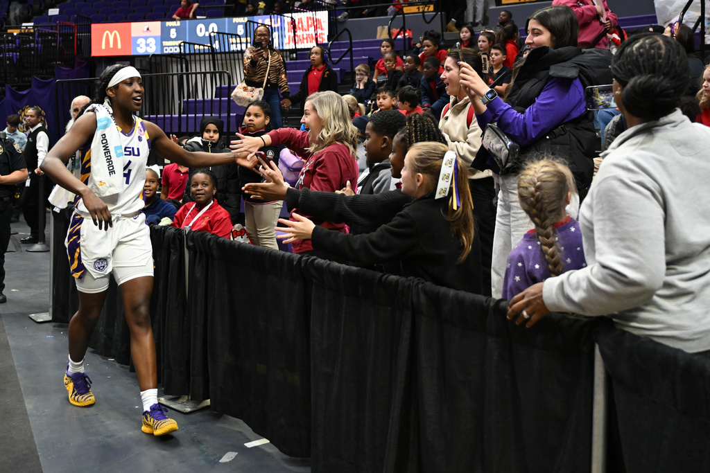 LSU guard Flau'Jae Johnson (4) greeting kids from Louisiana schools' 2025 Field Trip Day following an NCAA college basketball game against Morgan State, Tuesday, Dec. 16, 2025, in Baton Rouge, La. (AP Photo/Ella Hall)