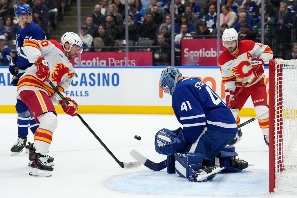 Toronto Maple Leafs goaltender Anthony Stolarz (41) makes a save on Calgary Flames forward Blake Coleman (20) during first period NHL hockey action in Toronto, Tuesday, Oct. 28, 2025. (Nathan Denette/The Canadian Press via AP)