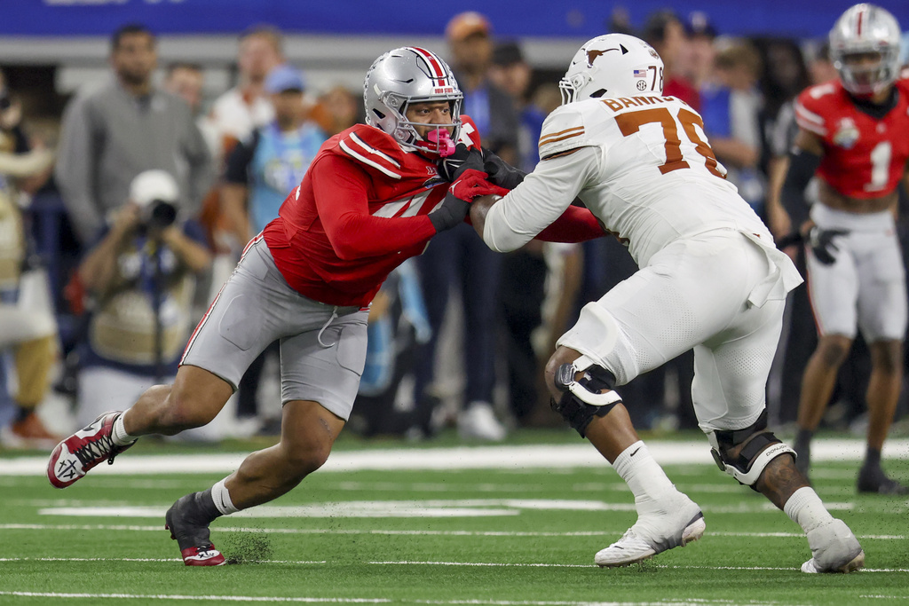 FILE - Ohio State defensive end JT Tuimoloau (44) rushes while being blocked by Texas offensive lineman Kelvin Banks Jr. (78) during the Cotton Bowl College Football Playoff semifinal game, Jan. 10, 2025, in Arlington, Texas. (AP Photo/Gareth Patterson, File)